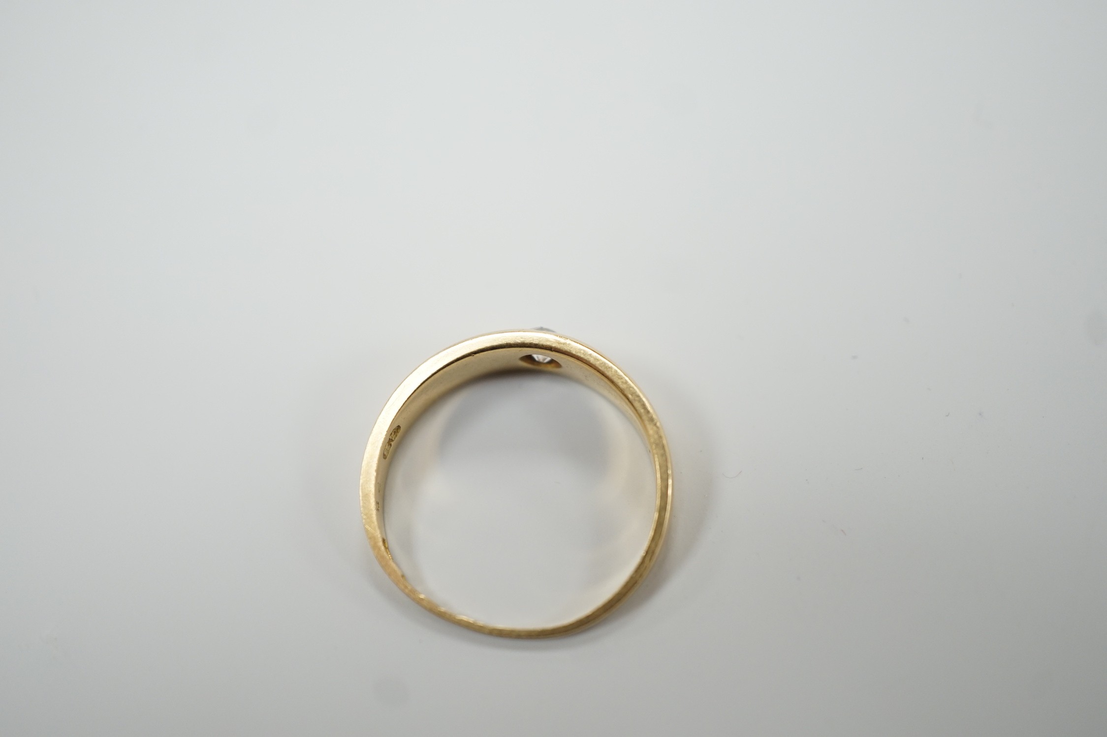 An early 20th century 18ct gold and gypsy set solitaire diamond ring, size M, gross weight 3.2 grams